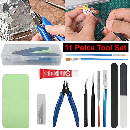 Plastic model kit and tools, hobby workplace background top view